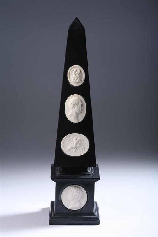 Appraisal: BLACK COMPOSITION OBELISK th century Inset with four carved sandstone