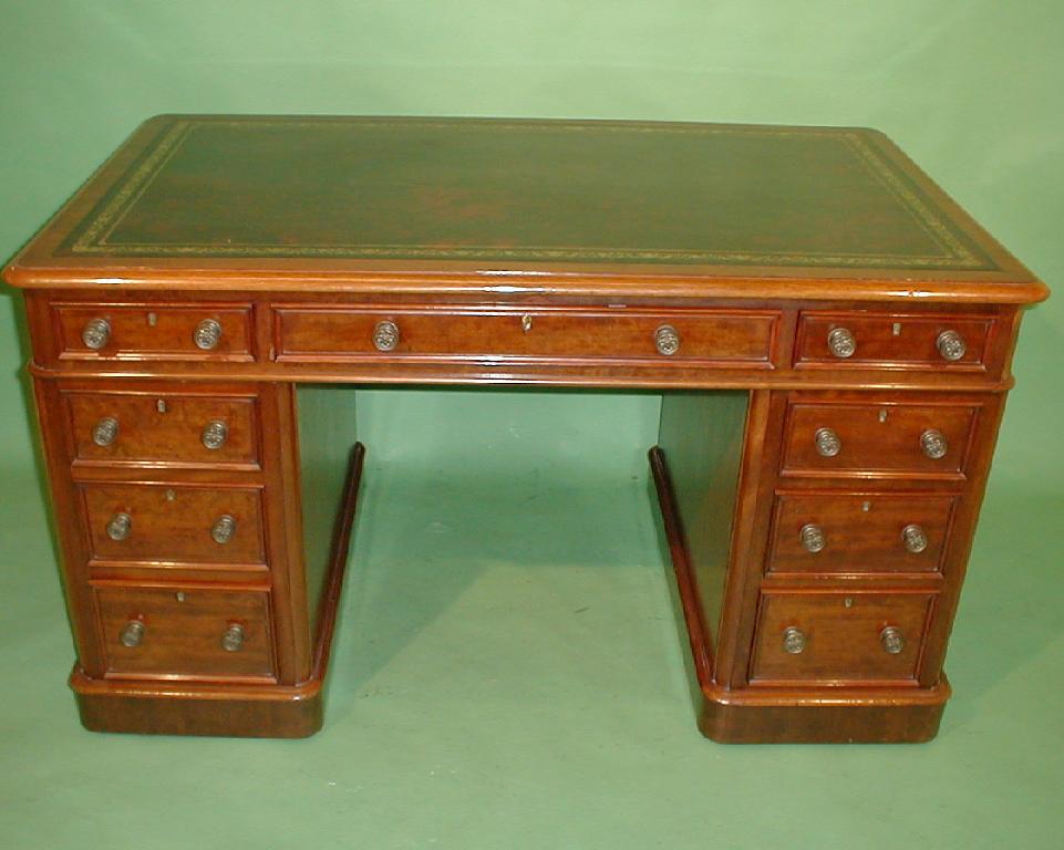 Appraisal: A Victorian mahogany kneehole desk with an arrangement of frieze