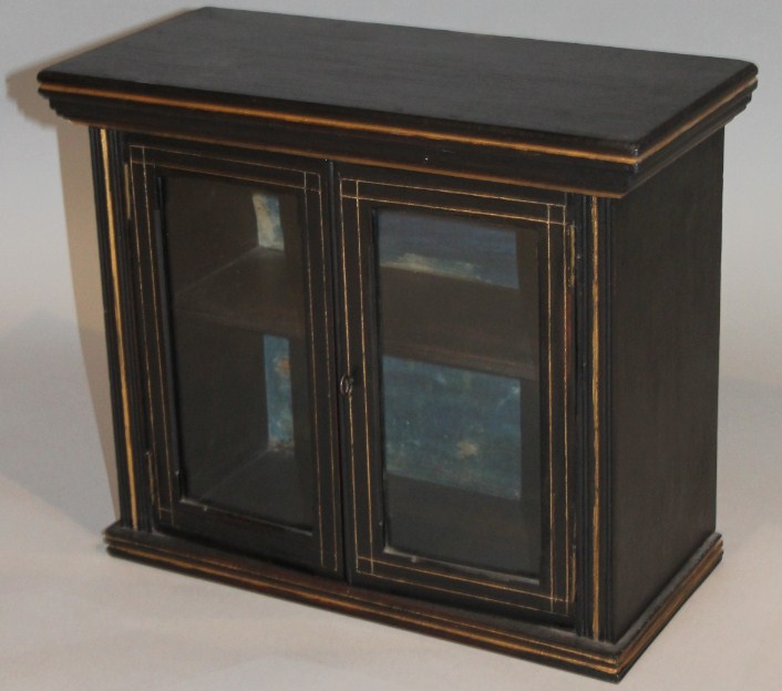 Appraisal: An Edwardian ebonised hanging cupboard the rectangular over hanging top