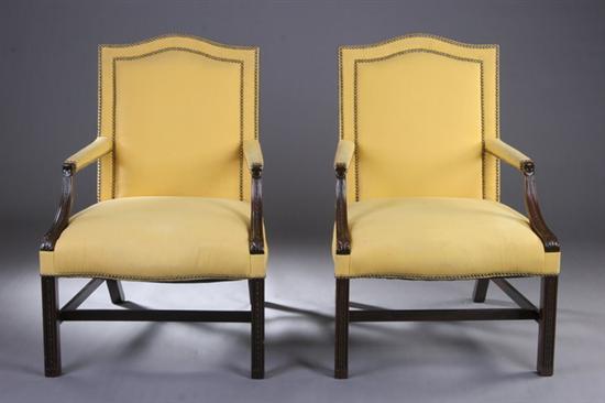 Appraisal: PAIR CHIPPENDALE STYLE LIBRARY CHAIRS th century Each nailed yellow