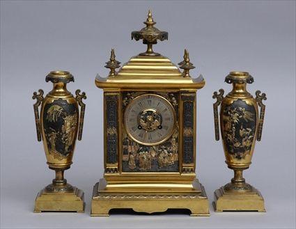 Appraisal: FRENCH CHINOISERIE GILT-BRASS AND BLACK-PAINTED THREE-PIECE CLOCK GARNITURE The silvered