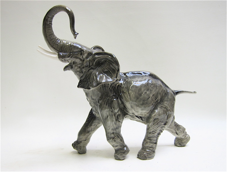 Appraisal: HUTSCHENREUTHER CERAMIC ELEPHANT FIGURINE with trunk raised upward representing good