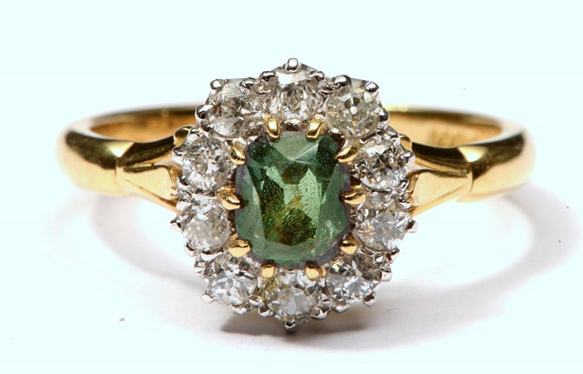 Appraisal: AN CT GOLD RING the oval setting with central alexandrite