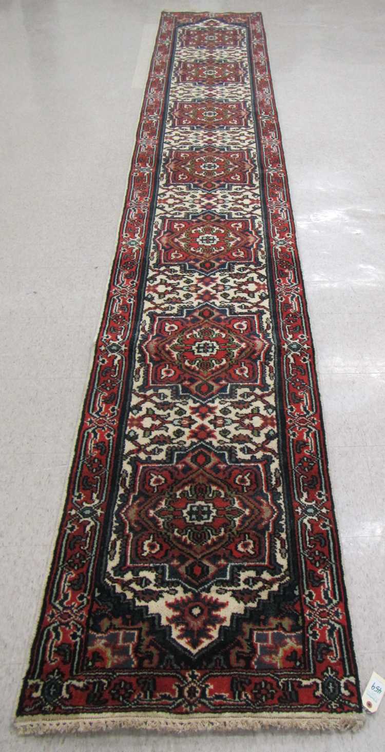 Appraisal: HAND KNOTTED ORIENTAL LONG RUG Persian Serapi design featuring seven