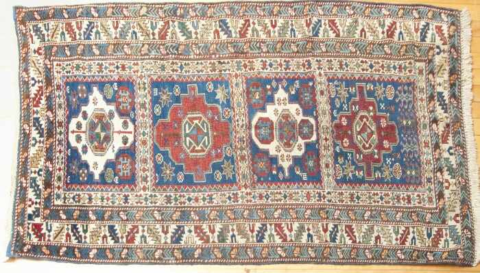 Appraisal: SHIRVAN RUG Worked with four red and ivory stepped medallions