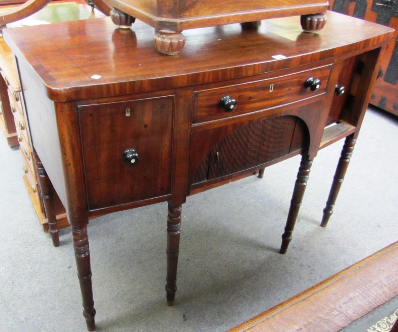 Appraisal: A Regency mahogany bowfront sideboard with three frieze drawers and