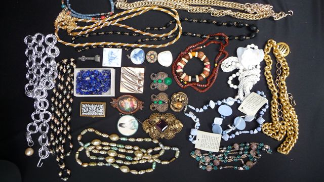 Appraisal: A box of costume jewellery containing chain belts jet beads