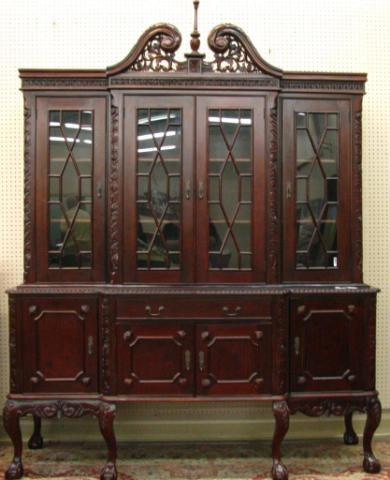 Appraisal: Chippendale style mahogany china cabinet pierce-carved arch top two-piece construction