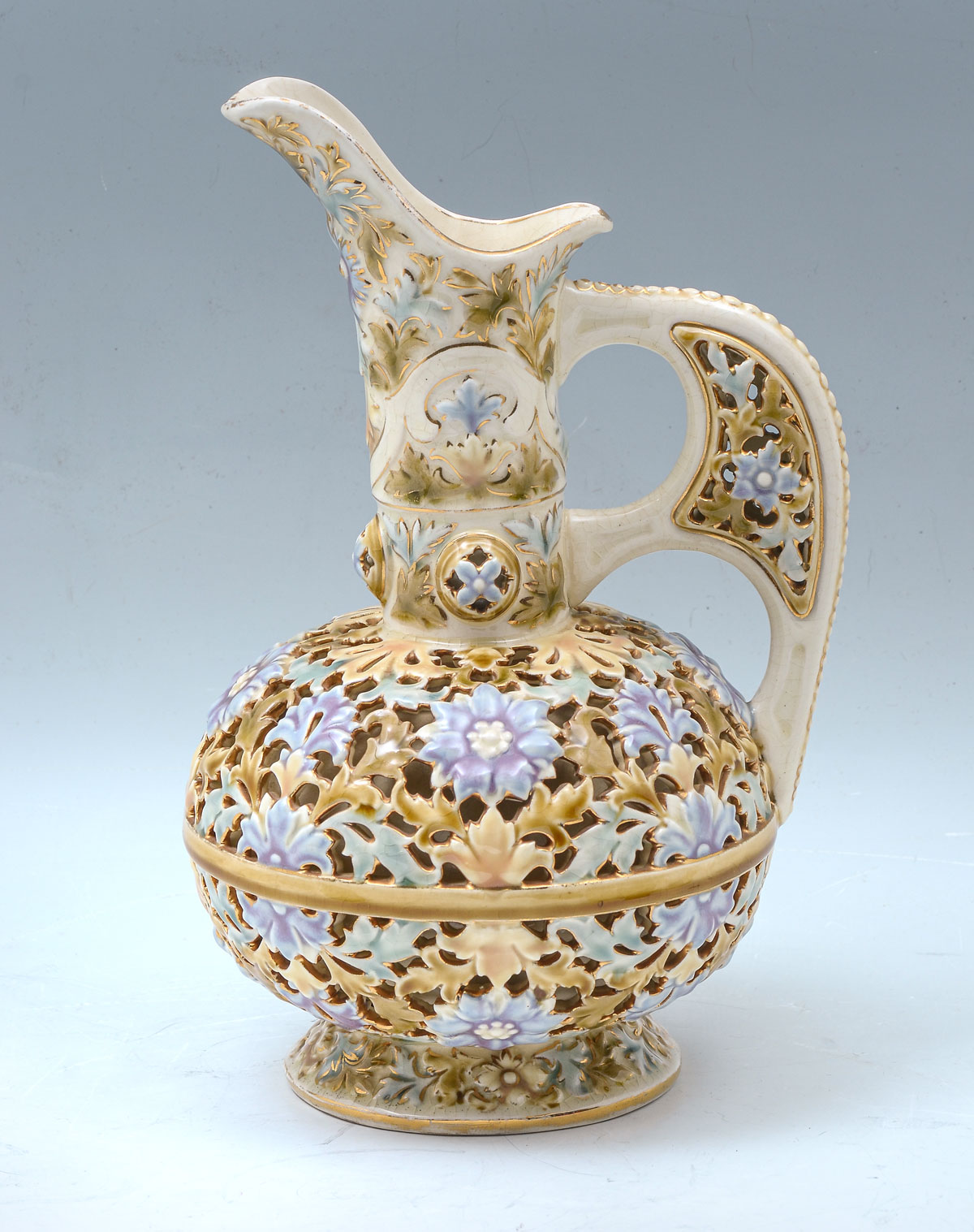 Appraisal: RETICULATED ZSOLNAY PITCHER Tall Zsolnay reticulated pitcher having an overall