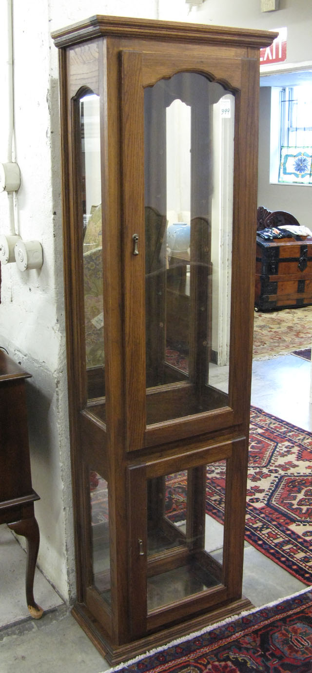 Appraisal: AN OAK AND GLASS CURIO CABINET American modern with upper