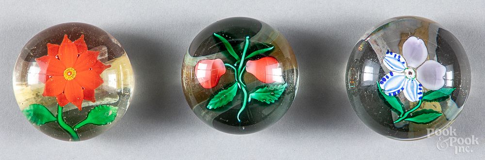 Appraisal: Three glass floral paperweights Three glass floral paperweights dia Condition