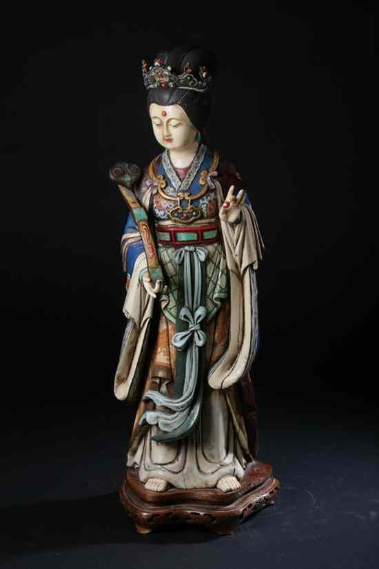 Appraisal: CHINESE IVORY AND POLYCHROME WOOD FIGURE OF GUANYIN Ivory face