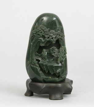 Appraisal: A Dark Green Carved Jade Boulder Chinese A smoothly polished