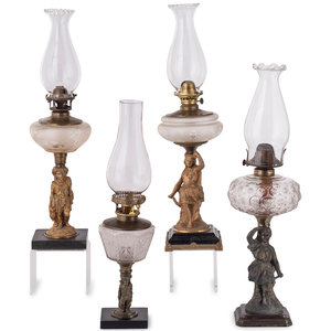 Appraisal: Four Gilt Metal and Glass Figural Oil Lamps Late th