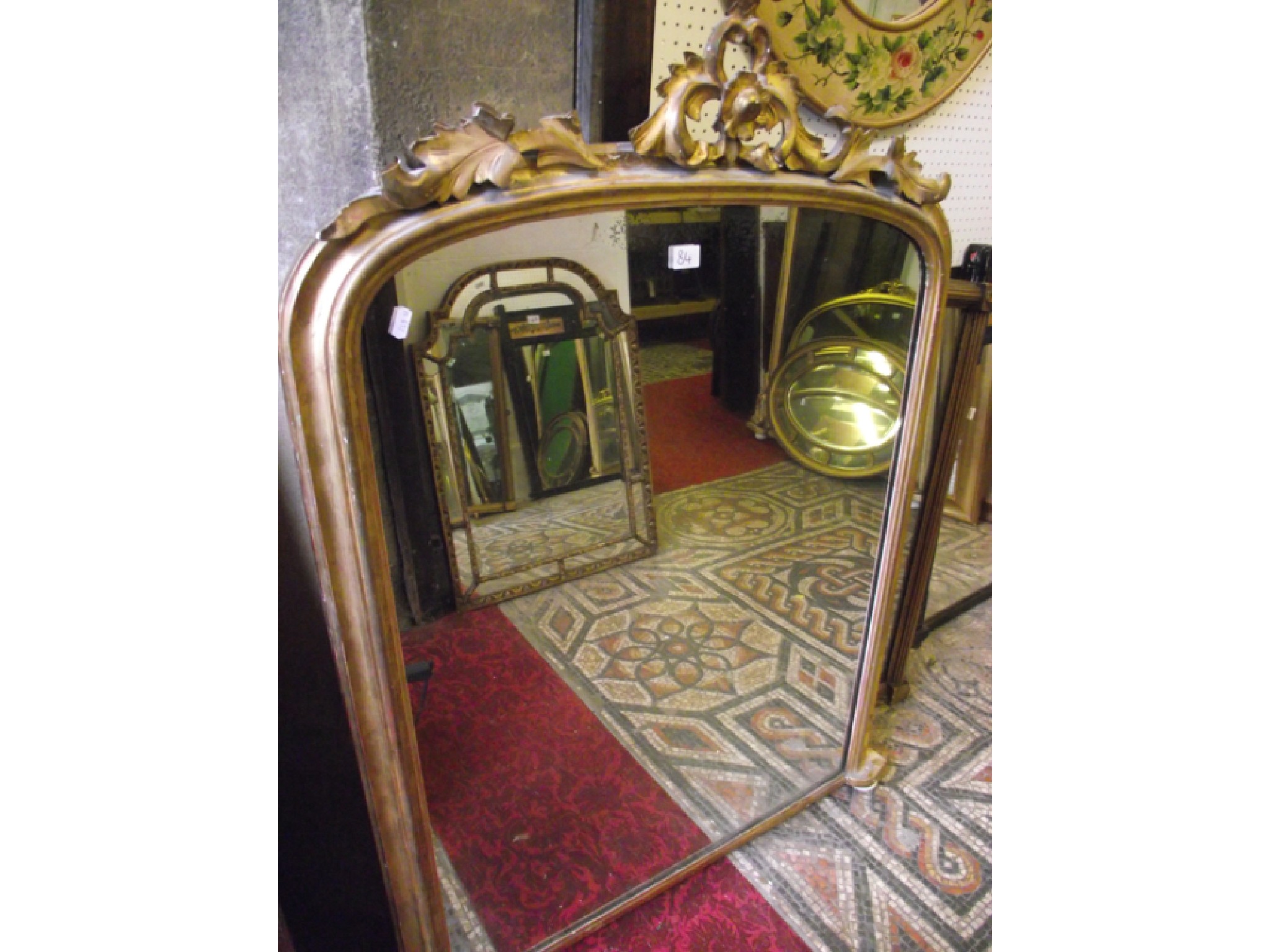 Appraisal: A Victorian gilt framed overmantle mirror of arched form with