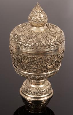 Appraisal: An Eastern white metal covered bowl with stand embossed warriors