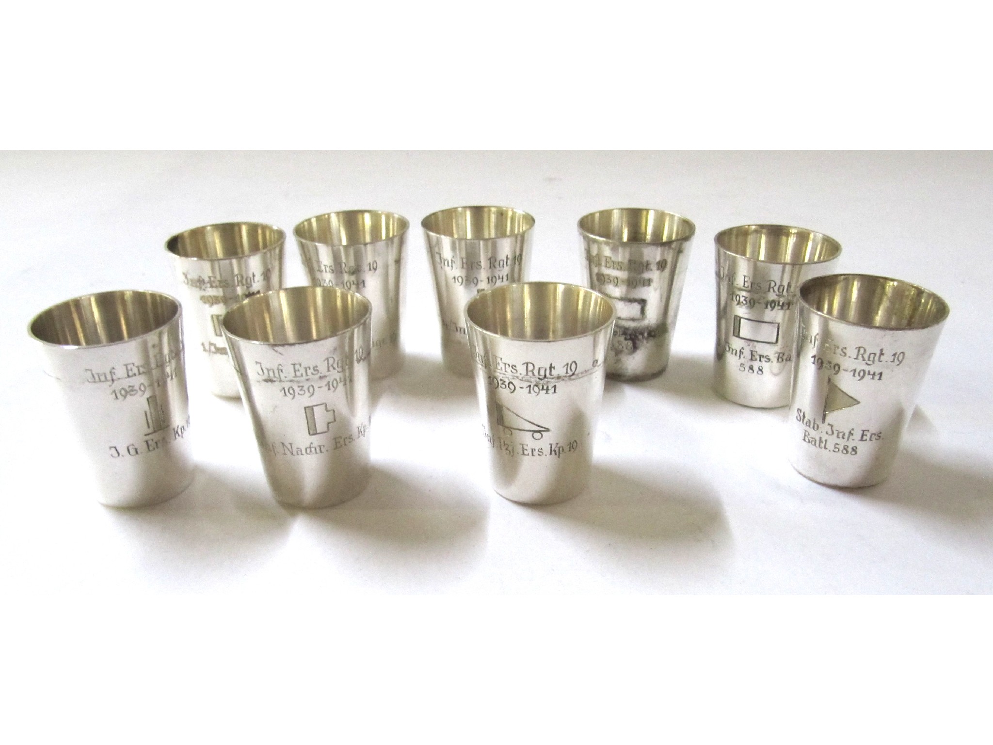 Appraisal: A set of nine silver plated tot cups inscribed with