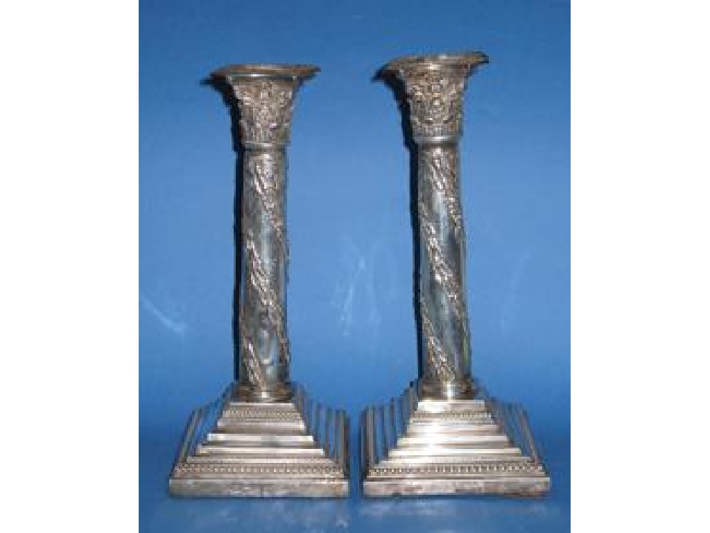 Appraisal: A PAIR OF LATE VICTORIAN CANDLESTICKS the cylindrical columns decorated