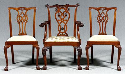 Appraisal: Three Chippendale style dining chairs finely carved mahogany open-arm chair