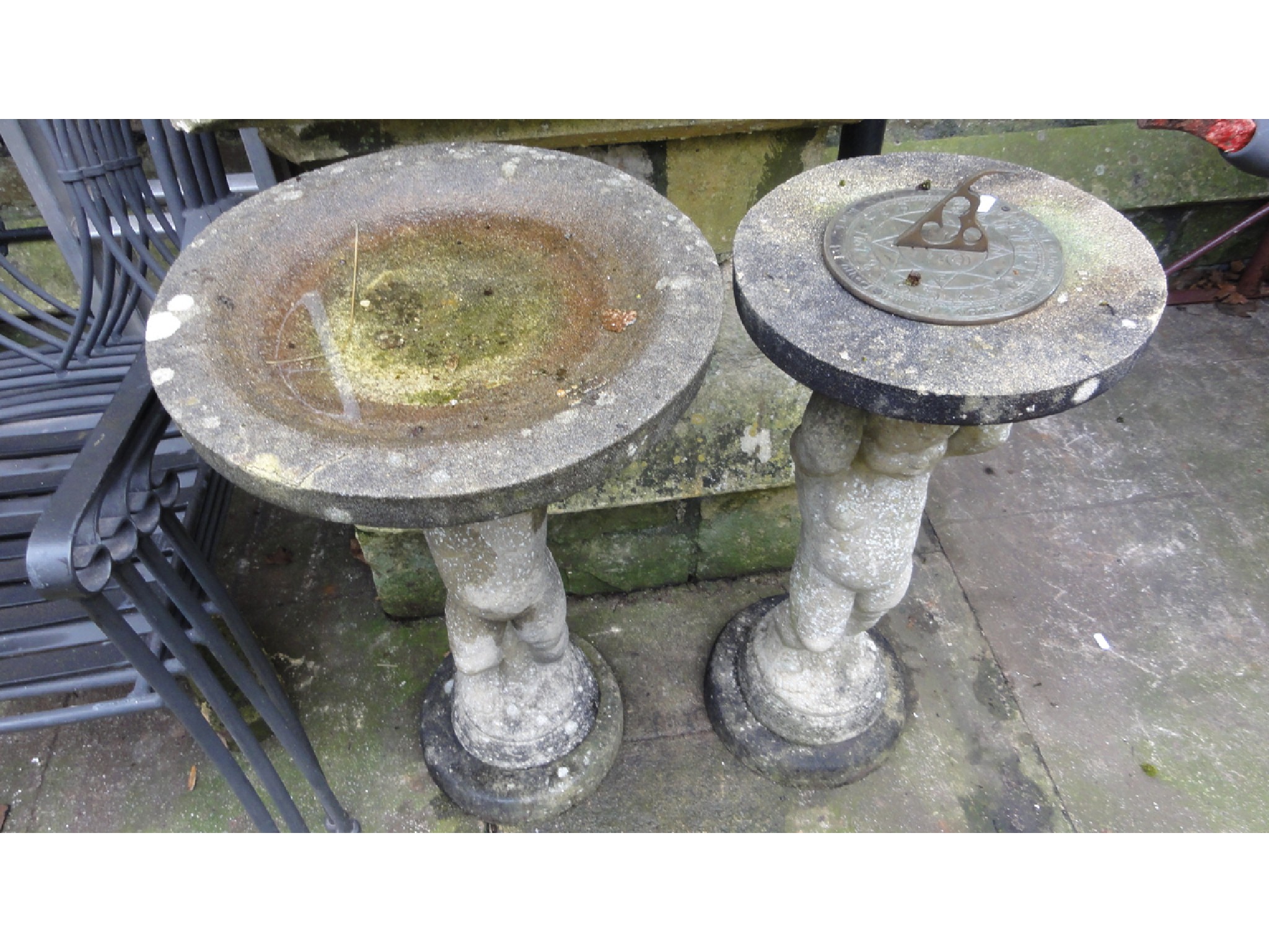 Appraisal: A weathered cast composition stone three sectional bird bath the