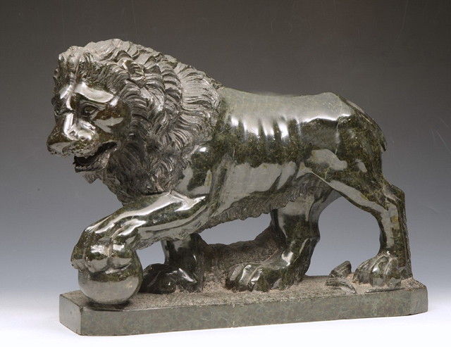 Appraisal: A CARVED CLASSICAL STYLE SERPENTINE MODEL OF A LION with