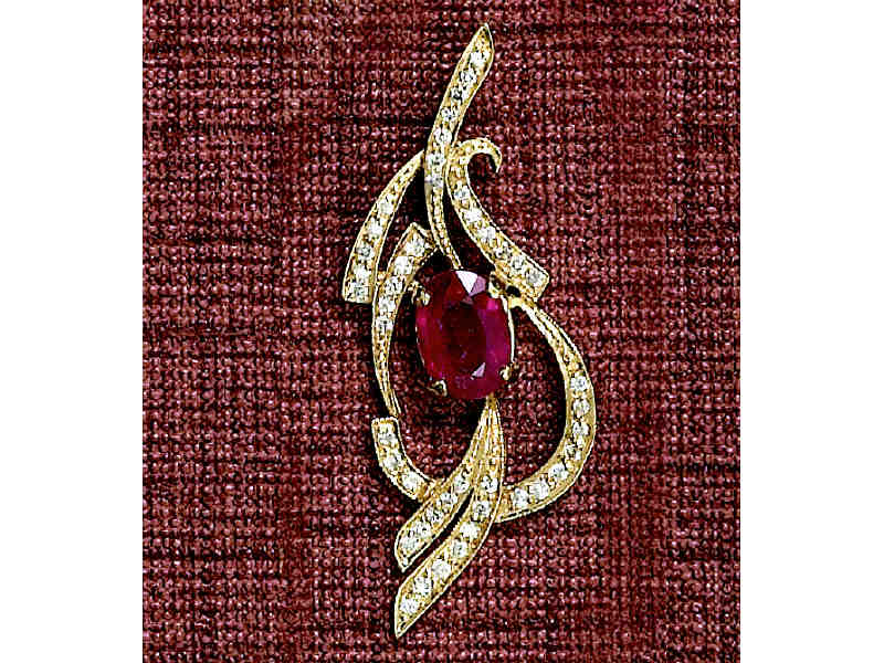 Appraisal: RUBY AND DIAMOND PENDANT k yellow gold pendant with flowing