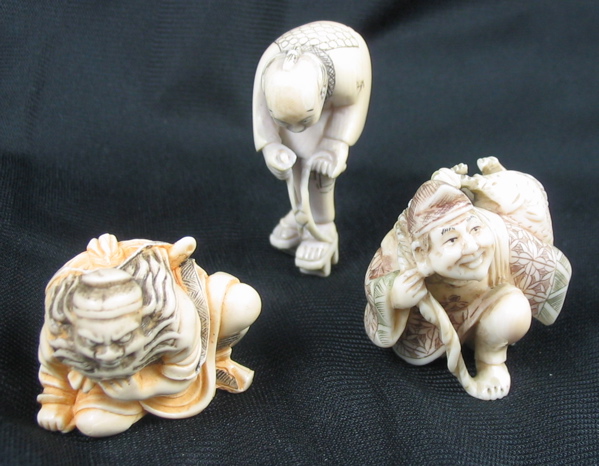 Appraisal: THREE IVORY CARVED ORIENTAL NETSUKE the first a man carrying