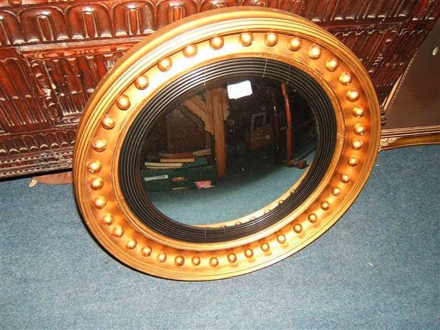 Appraisal: An antique circular gilt framed convex wall mirror diameter overall