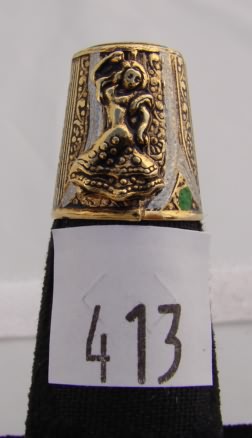 Appraisal: Gold tone thimble with dancing woman and green and white