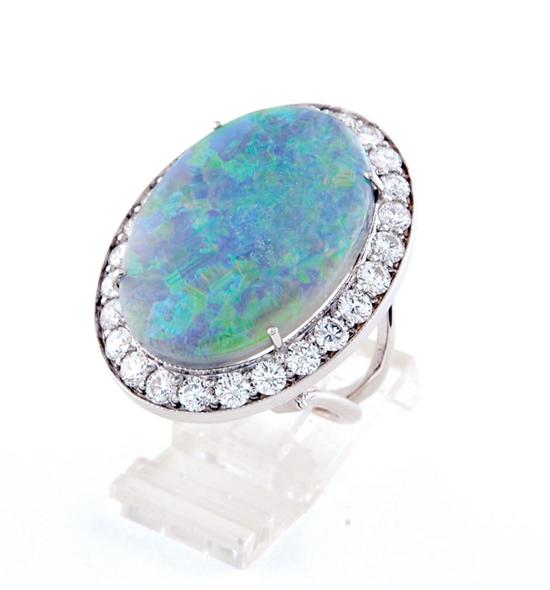 Appraisal: Black opal and diamond cocktail ring centered by cabochon-cut black