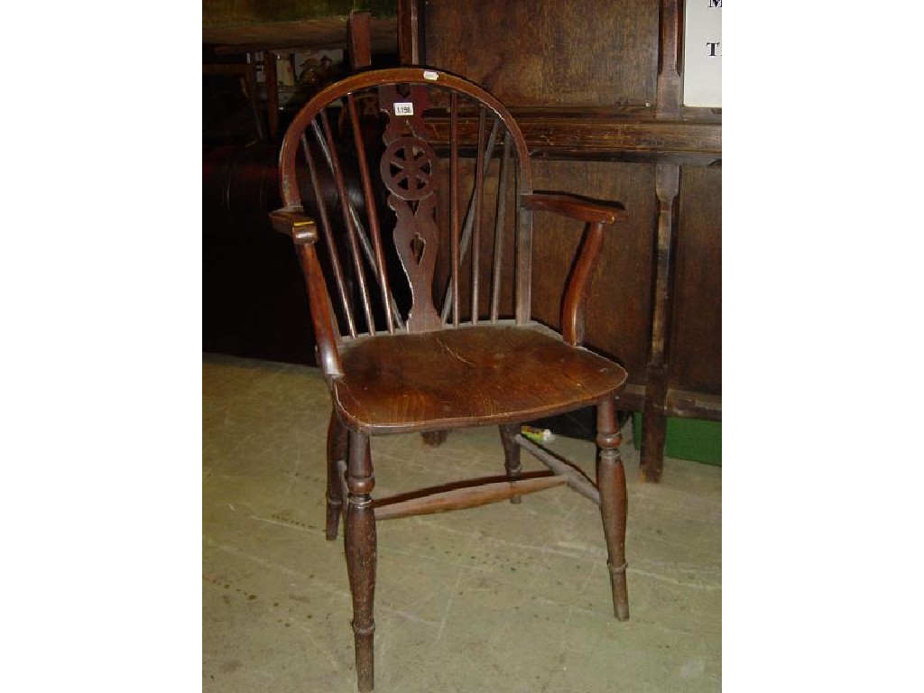 Appraisal: A th century Windsor wheel back kitchen elbow chair in