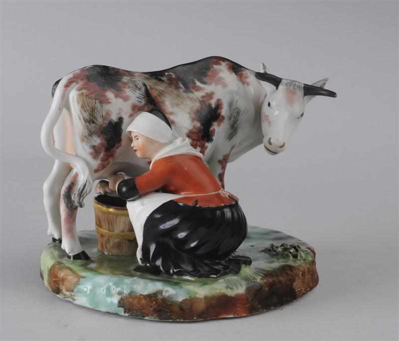 Appraisal: ROYAL COPENHAGEN PORCELAIN COW GROUP Impressed wave mark under belly