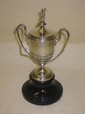 Appraisal: A GOLFING TROPHY of urn form with stiff leaf banding