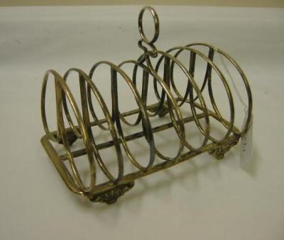 Appraisal: A GEORGE III TOAST RACK of rounded oblong form with