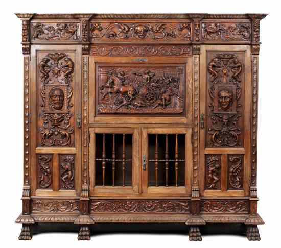 Appraisal: A Renaissance Revival Oak Cabinet having a shaped rectangular top