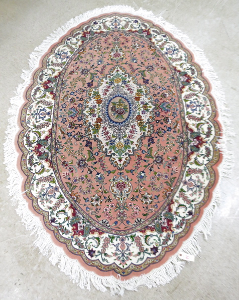 Appraisal: AN OVAL PERSIAN WOOL AND SILK AREA RUG floral and