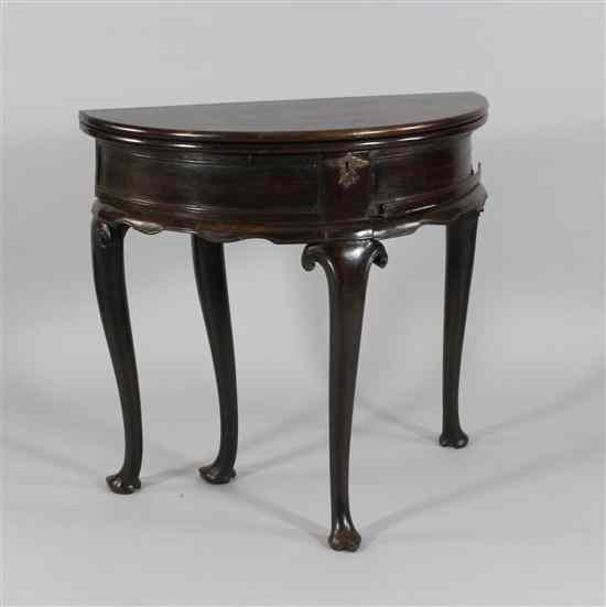 Appraisal: A George II mahogany double fold over demi lune tea