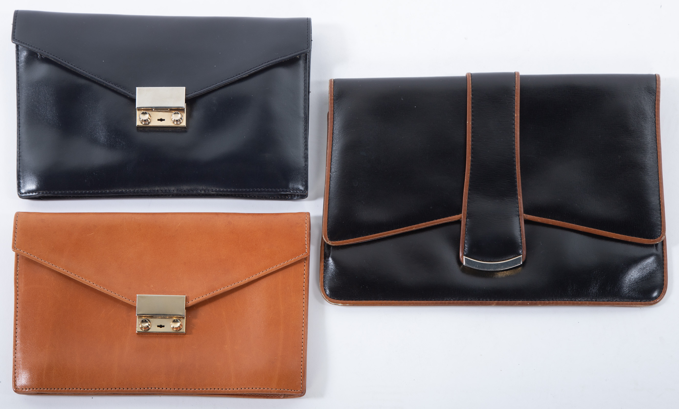 Appraisal: THREE LEATHER ENVELOPE CLUTCHES largest is in H in W