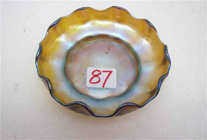 Appraisal: TIFFANY IRIDESCENT ART GLASS BOWL gold with silver-blue highlights ruffled