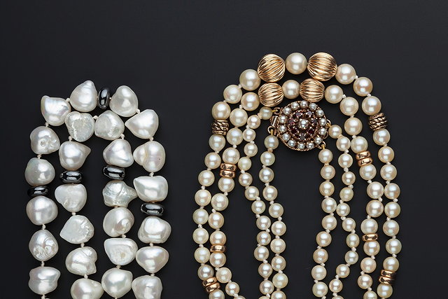 Appraisal: A DOUBLE ROW GRADUATED CULTURED PEARL NECKLACE with gold-coloured spacer