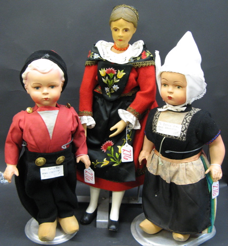 Appraisal: THREE INTERNATIONAL WOOD DOLLS Two are a pair of Dutch