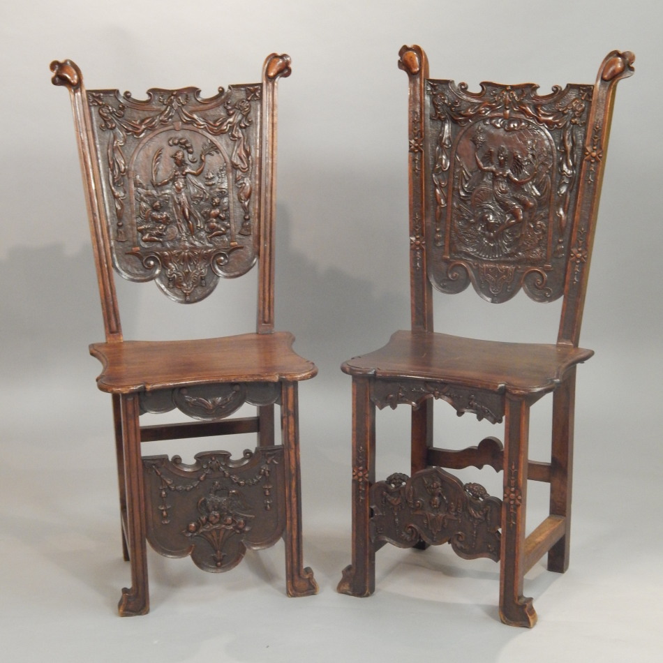 Appraisal: A pair of Continental walnut hall chairs each back carved