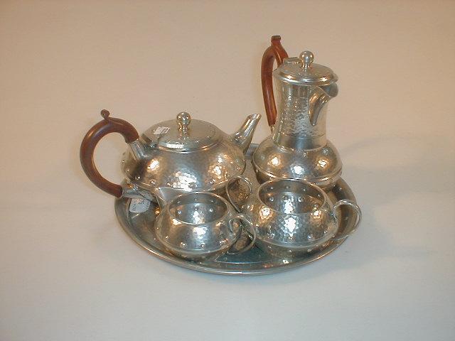 Appraisal: A Homeland planished pewter five piece tea service comprising tea