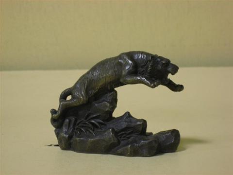 Appraisal: SMALL BRONZE CHARGING TIGER Above a rockwork base - h