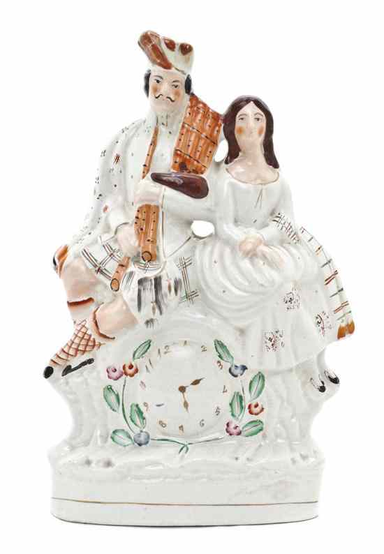 Appraisal: A Staffordshire Ceramic Figural Group depicting a Scottish couple seated