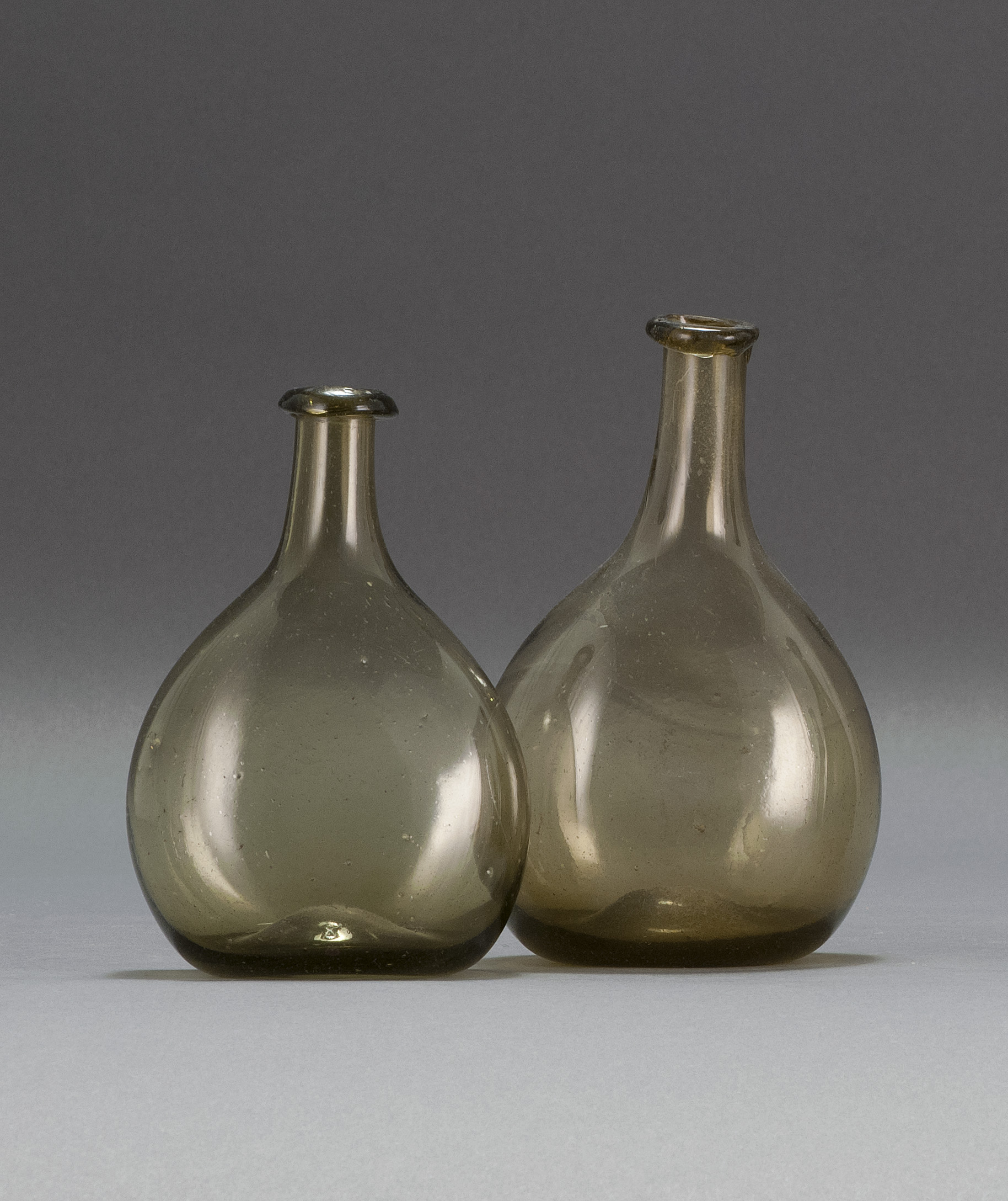 Appraisal: TWO FREE-BLOWN GLASS CHESTNUT FLASKS Early th CenturyBoth in olive