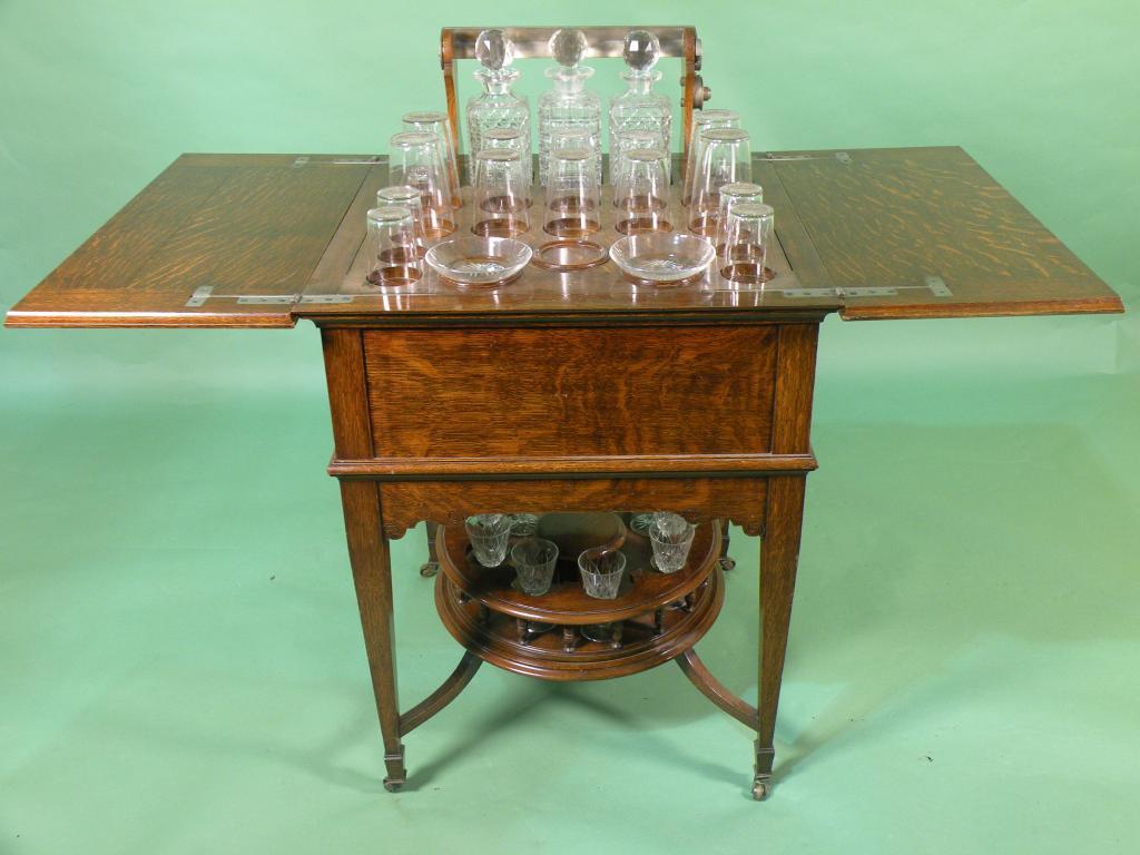 Appraisal: An Edwardian oak metamorphic drinks cabinet the rectangular top with