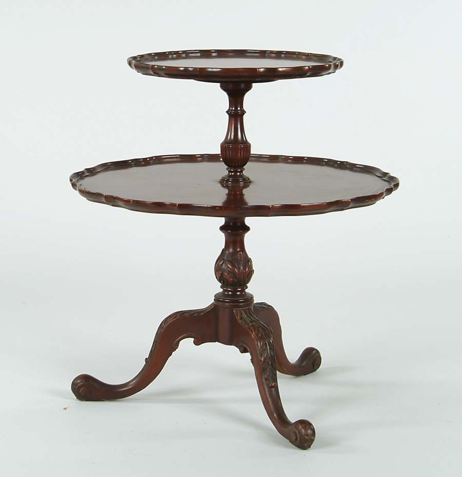 Appraisal: TWO TIER MAHOGANY CARVED STAND Pie crust form round top