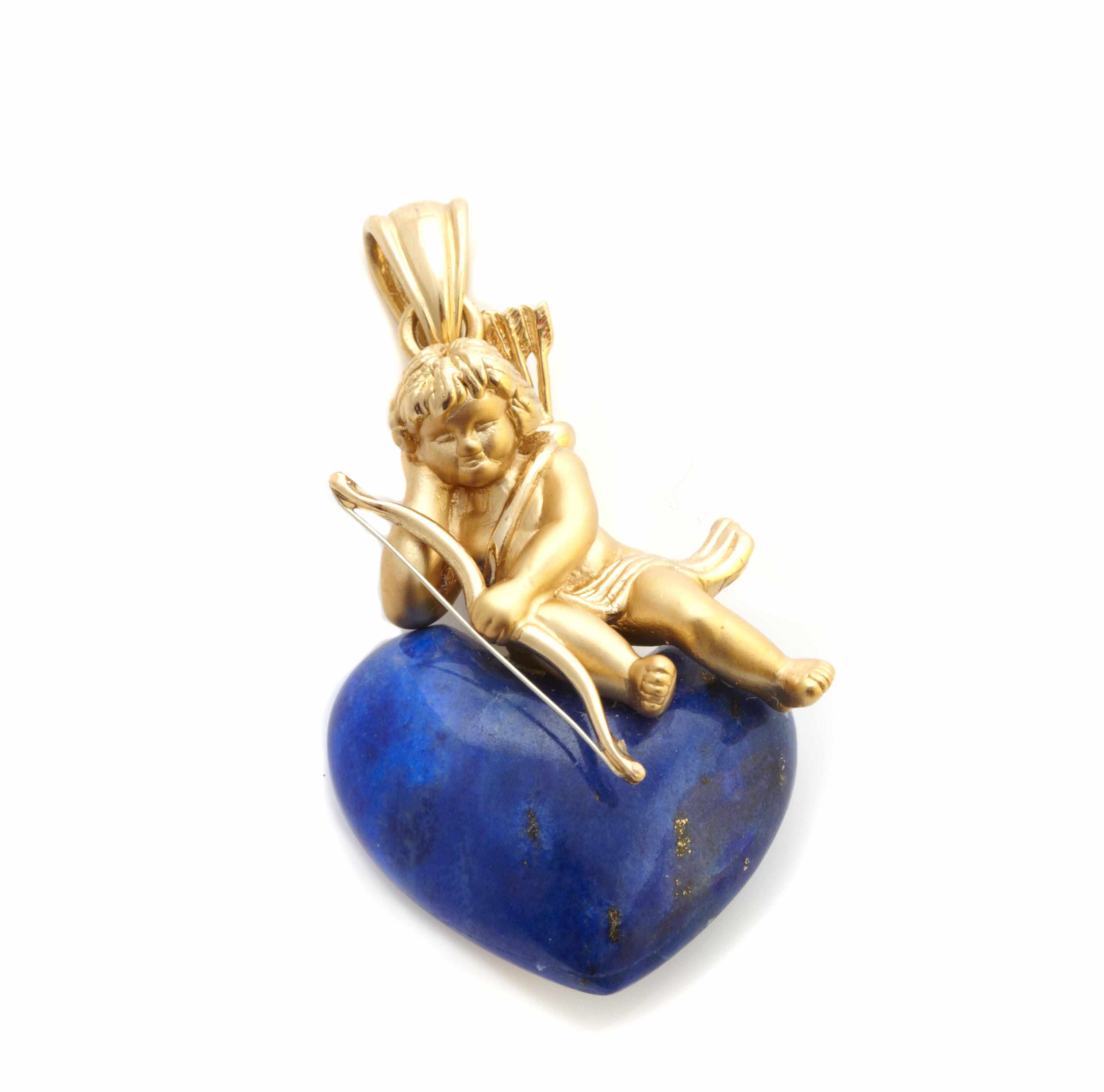 Appraisal: A lapis lazuli and gold cherub heart motif pendant maker's