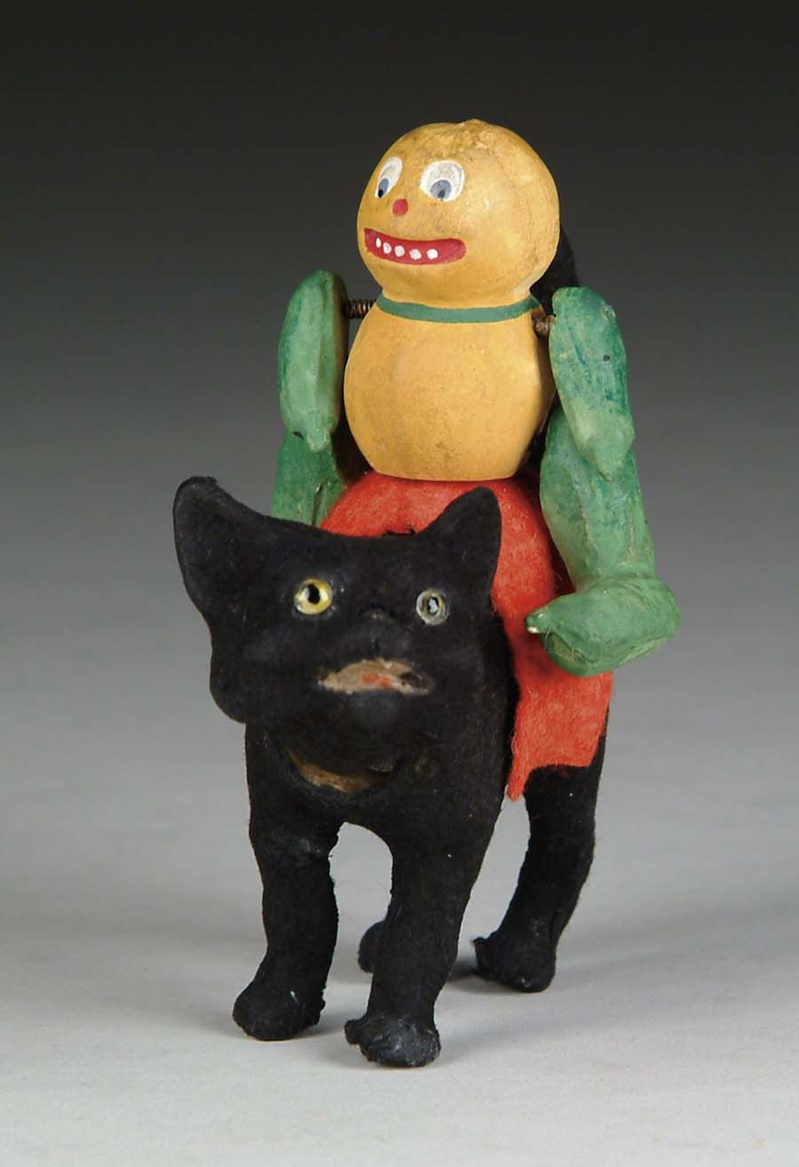 Appraisal: VEGGIE MAN ASTRIDE NODDING BLACK CAT A flocked nodding black